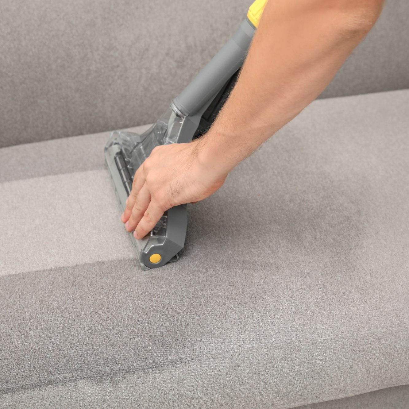 removing dirt from sofa with upholstery cleaner