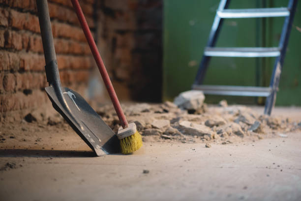 Shovel and broom on the dusty construction site floor background. Shovel and broom on the dusty construction site floor background.